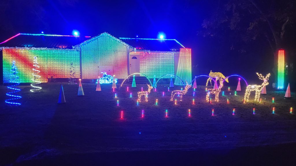 Full color Christmas lights covering Small home in Tuscaloosa, Alabama